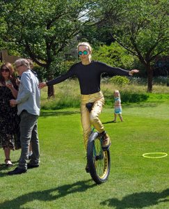 A circus entertainer on a unicycle.